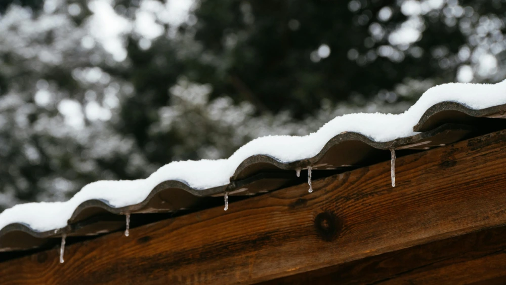 Snow-covered roof in Fort Collins showing signs of ice dam and winter roof stress